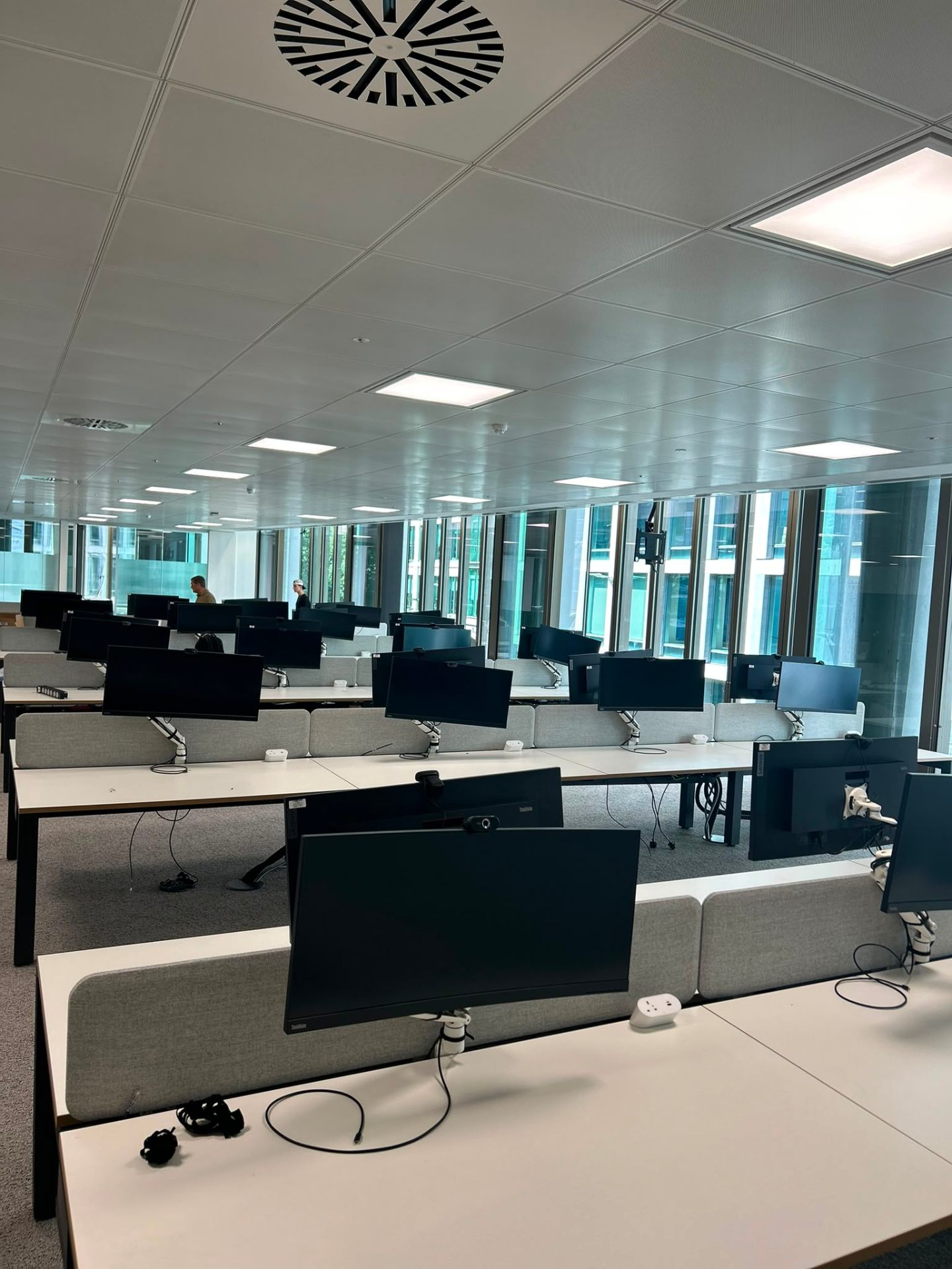Office desk fit-out with monitor arms and cable management, London