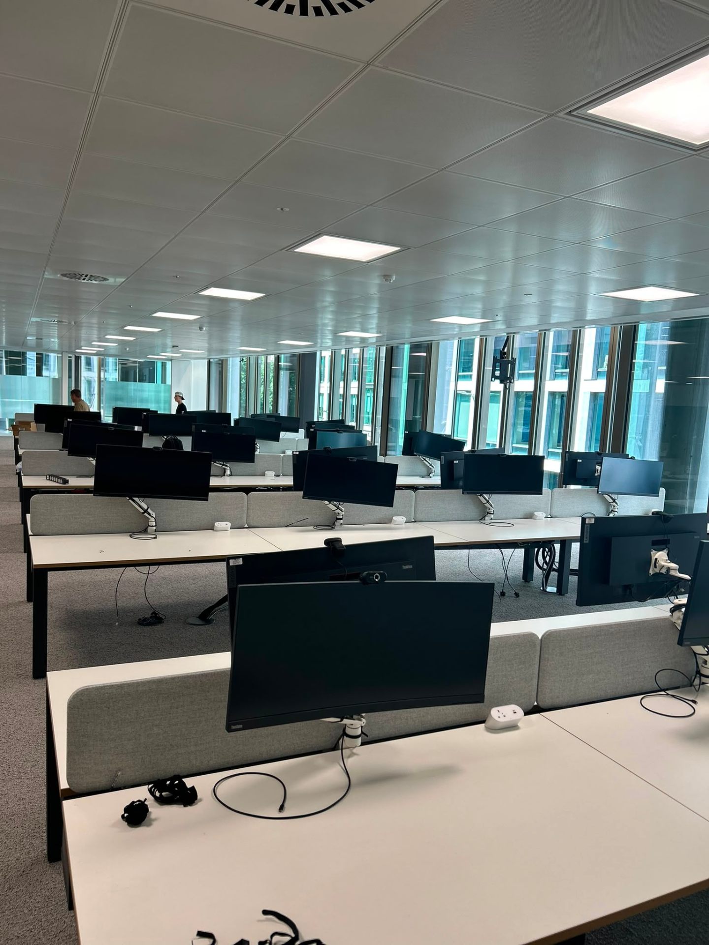 Large-scale office desk and monitor installation, London workplace fit-out